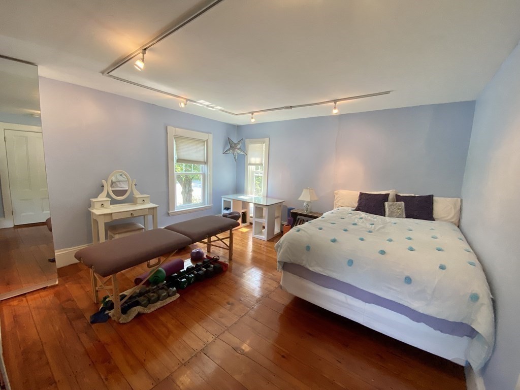 7 Grasshopper Lane Walpole, MA 02081 - Photo 29 of 42 a bedroom with a bed and wooden floor