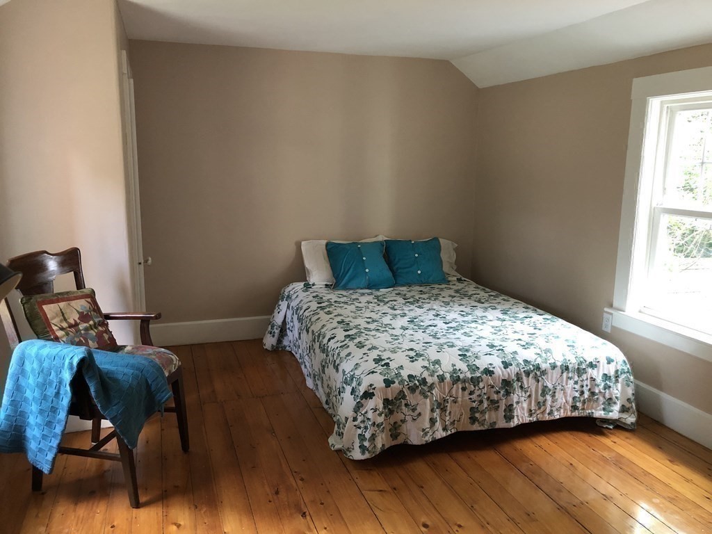 7 Grasshopper Lane Walpole, MA 02081 - Photo 31 of 42 a bedroom with a bed and wooden floor