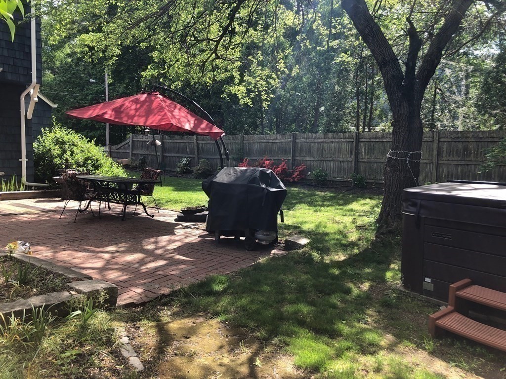 7 Grasshopper Lane Walpole, MA 02081 - Photo 39 of 42 a view of a backyard with a patio and garden