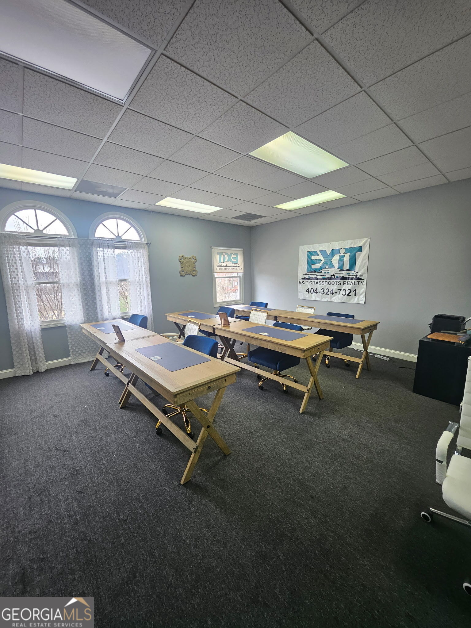 a living room with furniture pool table and windows