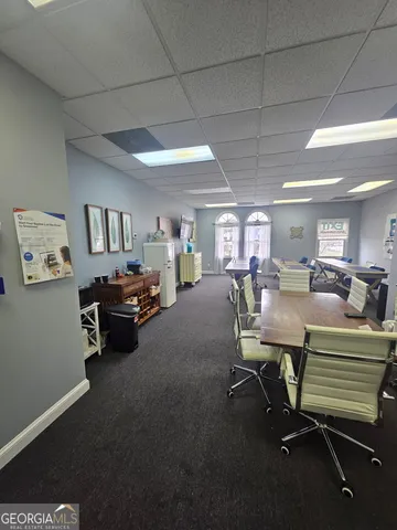 a room with gym equipment and a view of living room