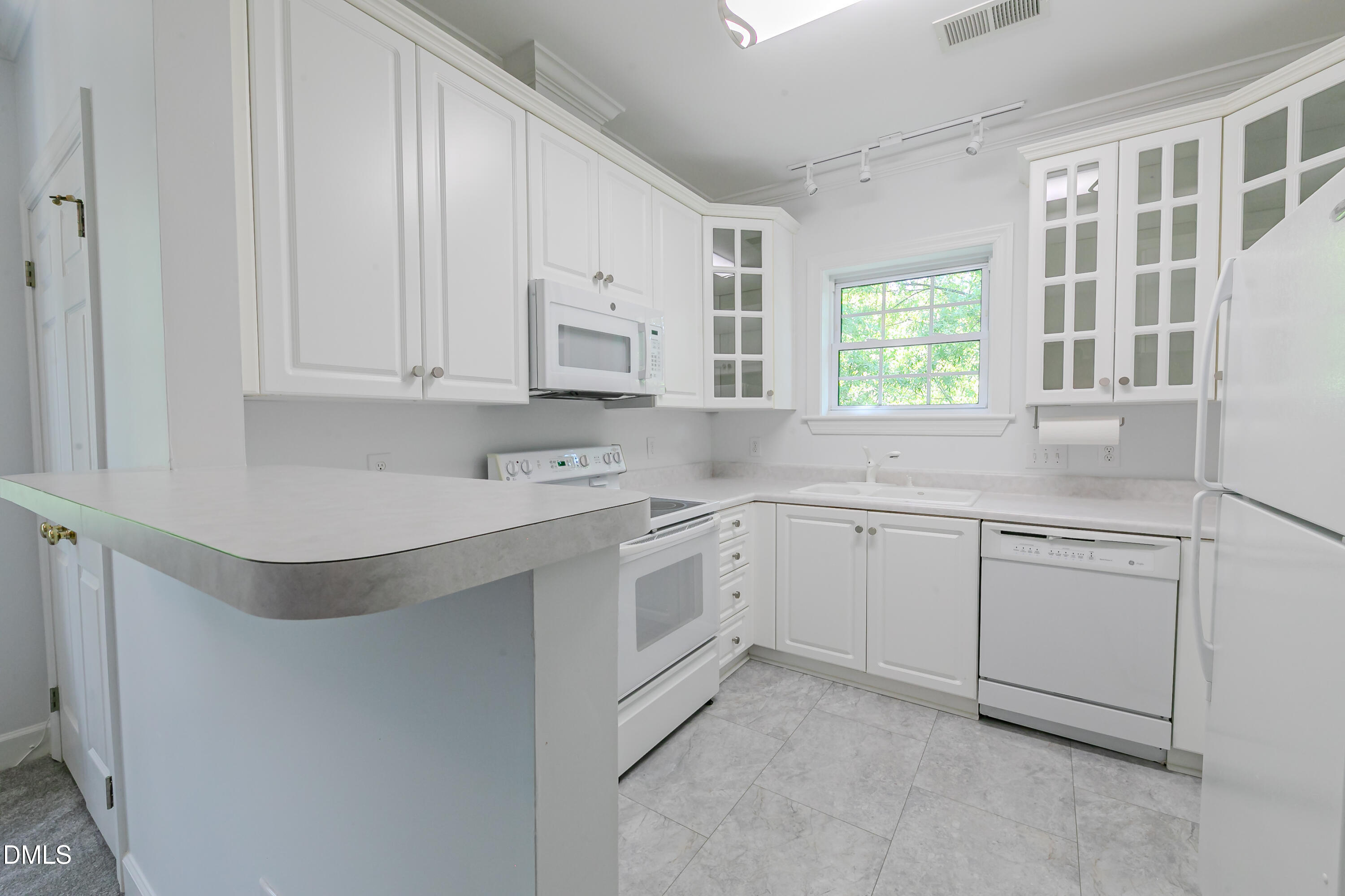 116 Northbrook Drive, Unit 305 Raleigh, NC 27609 - Photo 4 of 43 a kitchen with appliances cabinets and a sink