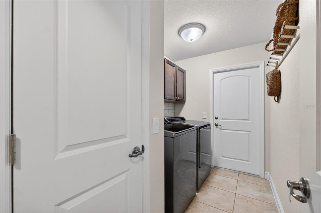 2429 Twin Lake View Road Winter Haven, FL 33881 - Photo 33 of 37 a kitchen with a refrigerator and cabinets