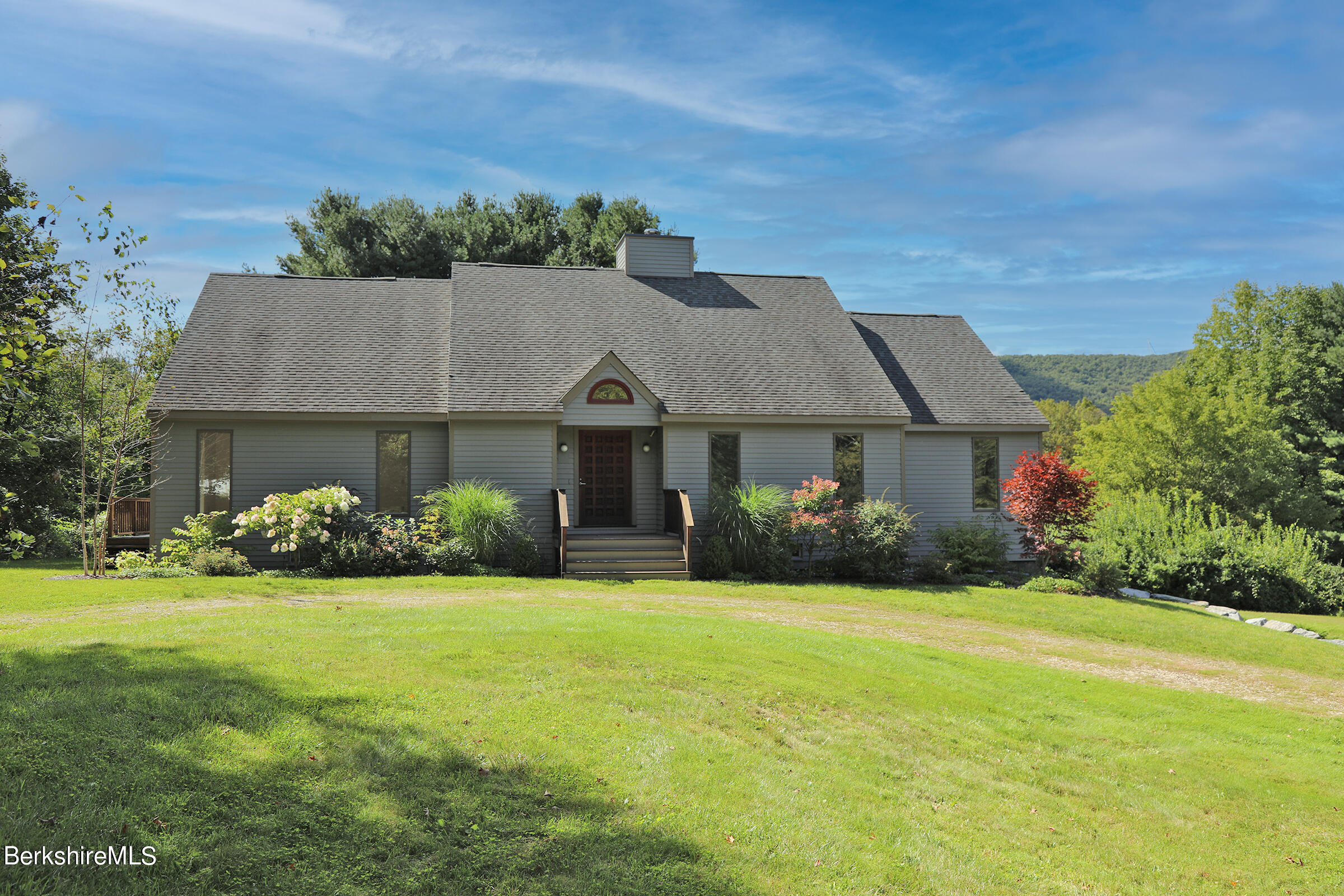 a front view of house with yard and green space