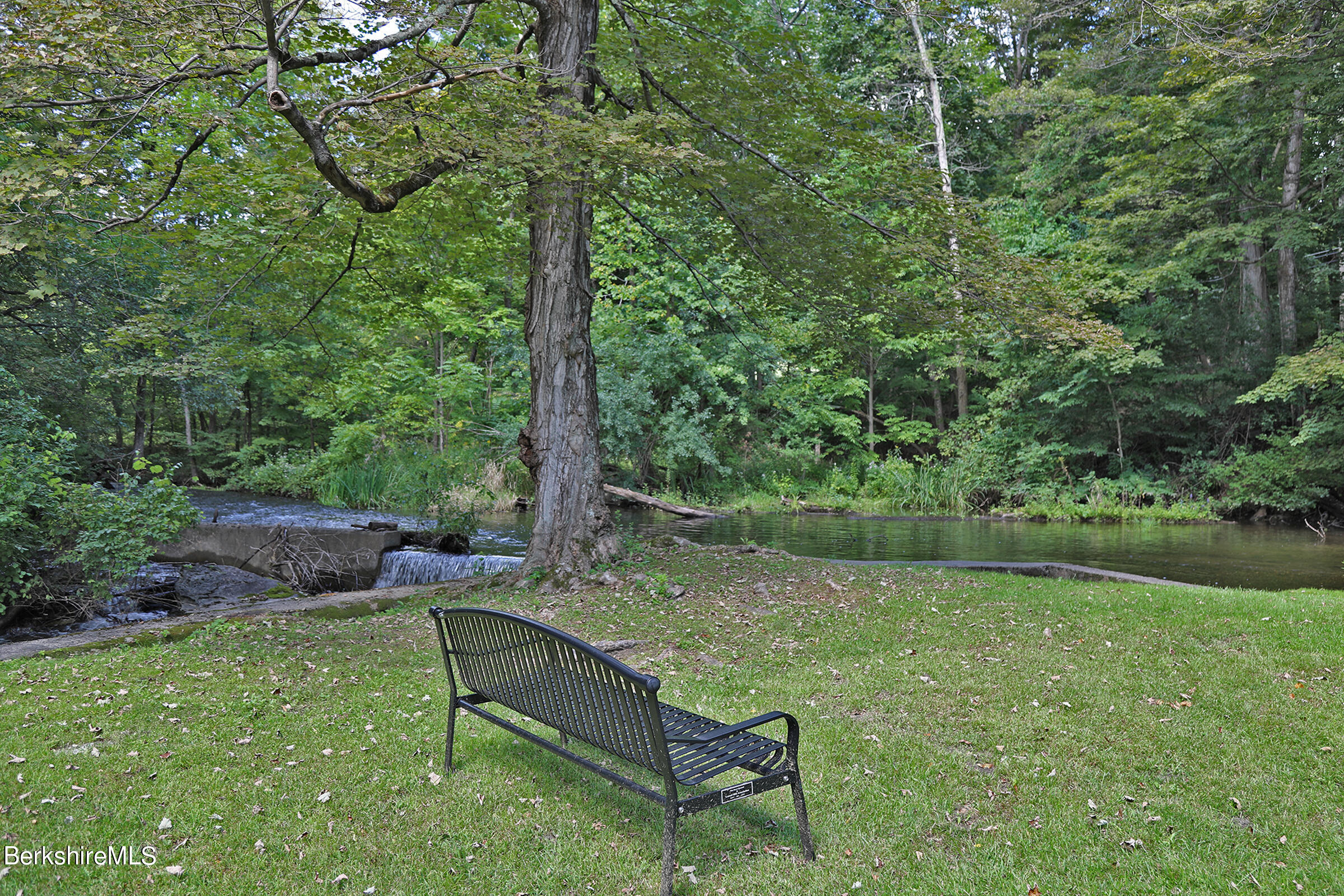 4 Hill Road Stockbridge, MA 01266 - Photo 37 of 41 a backyard of a house with lots of green space and fountain