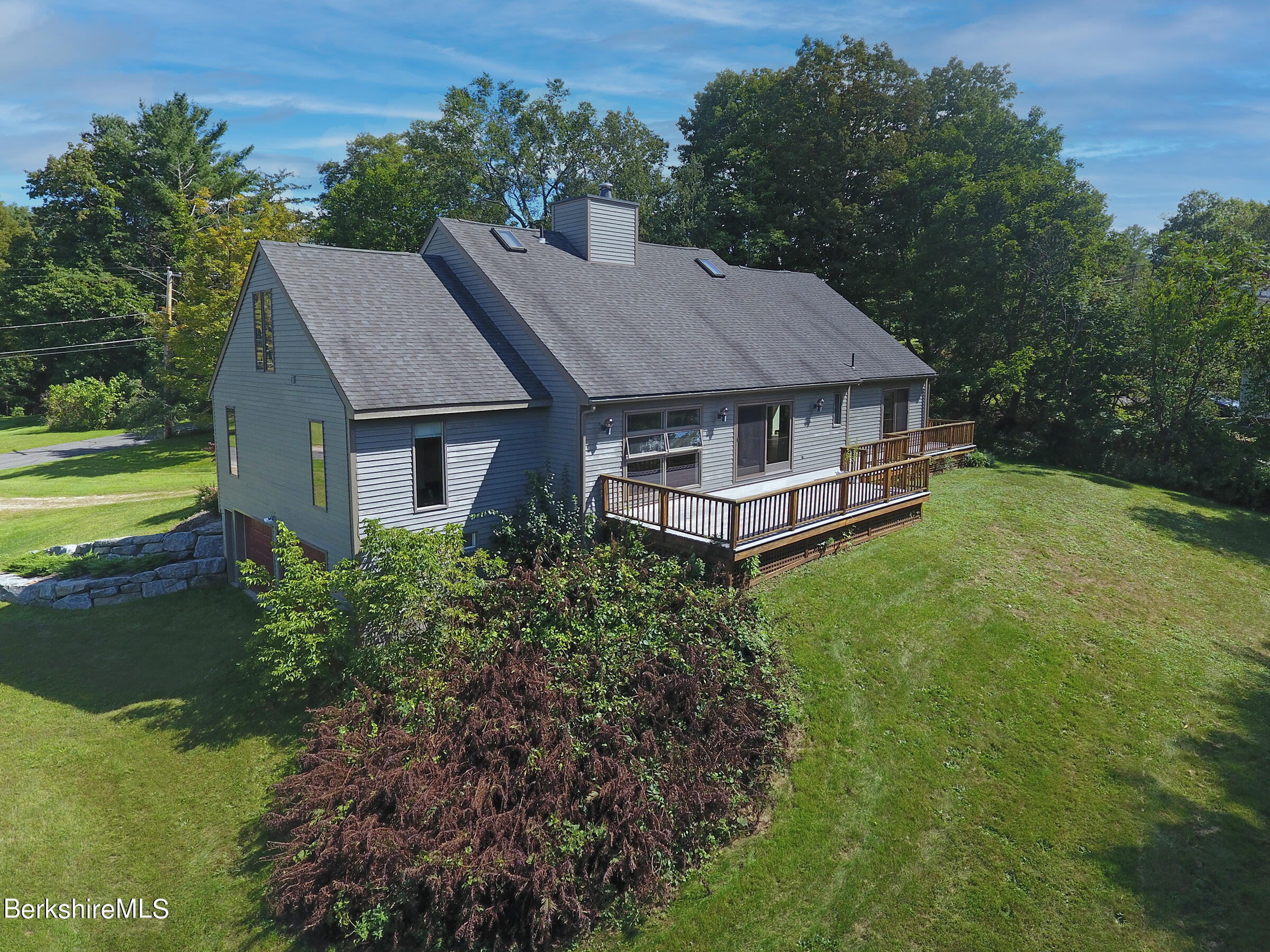 4 Hill Road Stockbridge, MA 01266 - Photo 6 of 41 a aerial view of a house with a yard table and chairs