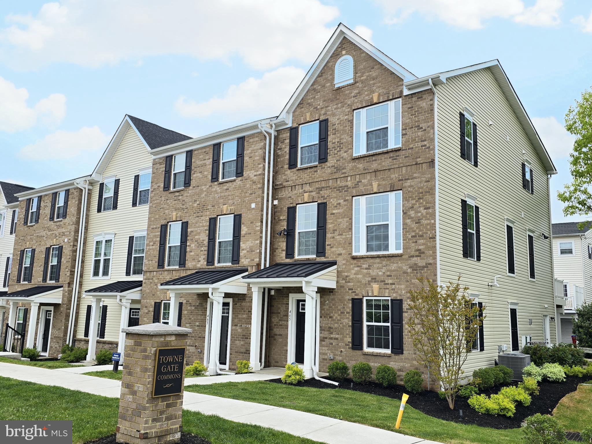 a front view of a house with a yard and outdoor seating