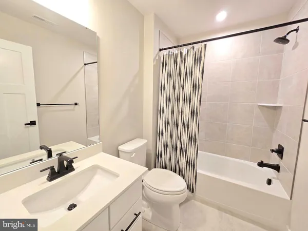 a bathroom with a sink mirror toilet and bathtub