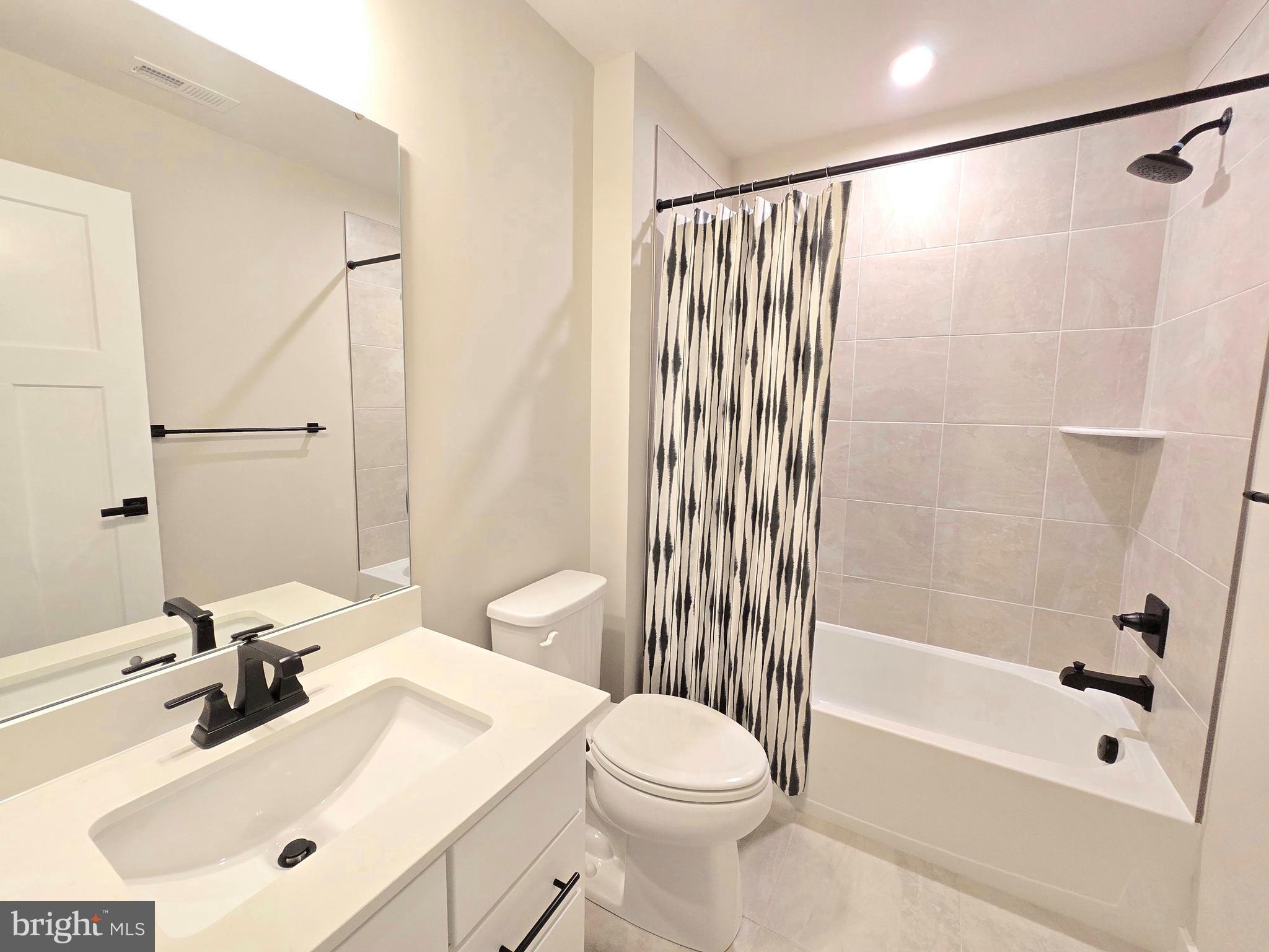 465 Market Street Souderton, PA 18964 - Photo 11 of 13 a bathroom with a sink mirror toilet and bathtub