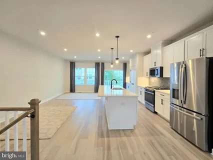 a kitchen with stainless steel appliances a refrigerator and a stove top oven