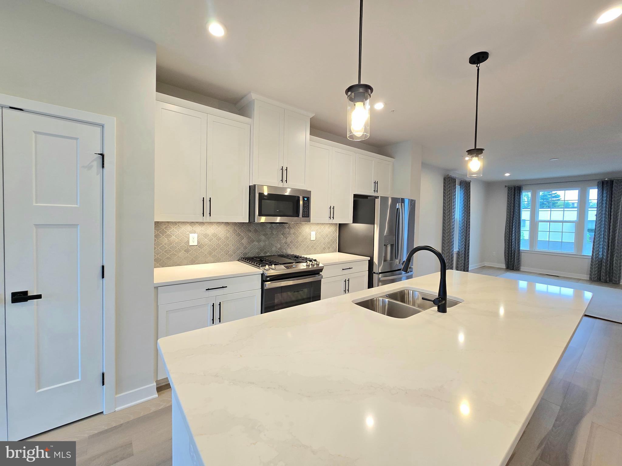 465 Market Street Souderton, PA 18964 - Photo 3 of 13 a kitchen with stainless steel appliances kitchen island granite countertop a sink a stove and refrigerator