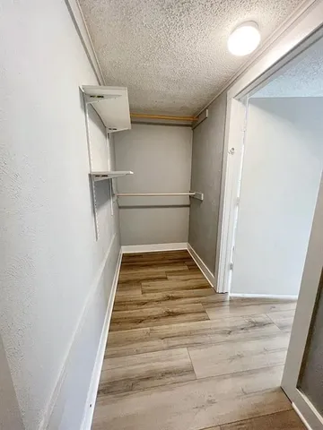 a kitchen with stainless steel appliances granite countertop a stove a refrigerator and a white cabinets