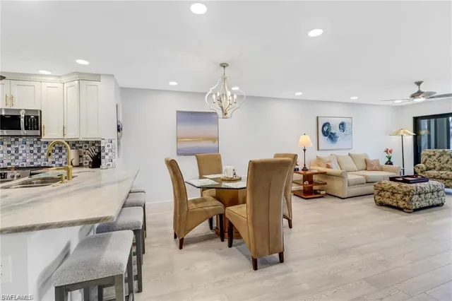 a bed sitting in a spacious bedroom next to a window