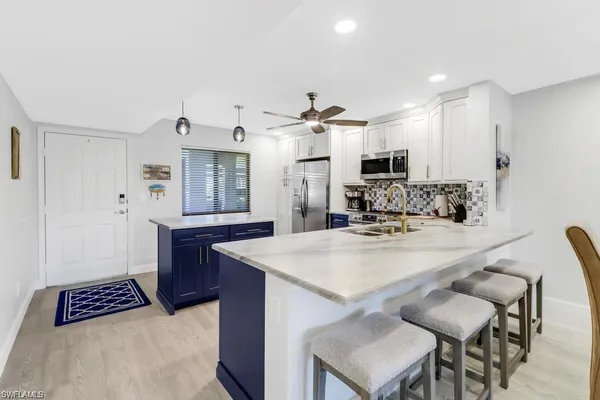 a view of kitchen with cabinets and wooden floor