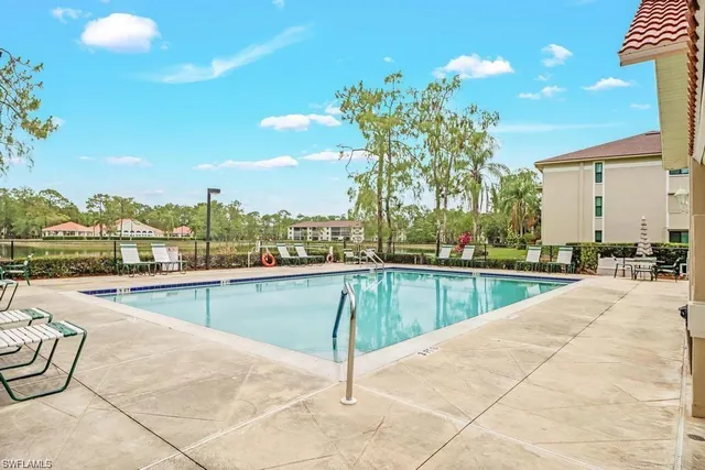 a room with lots of dining table furniture and a chandelier