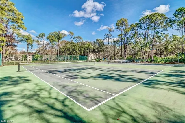 an aerial view of a house with a yard and lake view