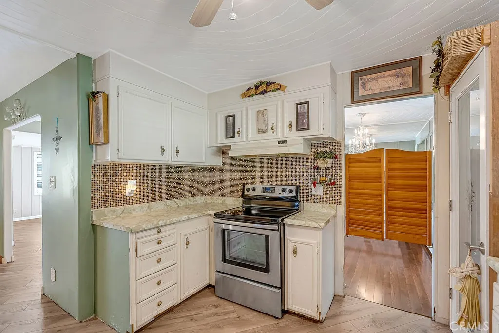9999 Foothill, Unit 48 Rancho Cucamonga, CA 91730 - Photo 18 of 38 a kitchen with stainless steel appliances granite countertop a stove and a refrigerator