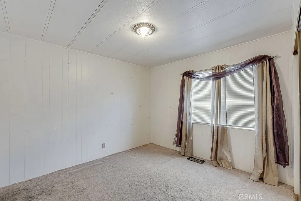 9999 Foothill, Unit 48 Rancho Cucamonga, CA 91730 - Photo 32 of 38 an empty room with closet and windows