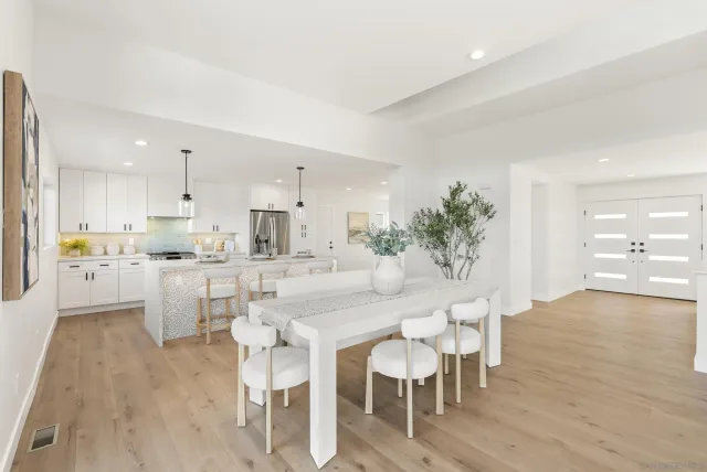 a large kitchen with kitchen island granite countertop a sink a counter top space and stainless steel appliances