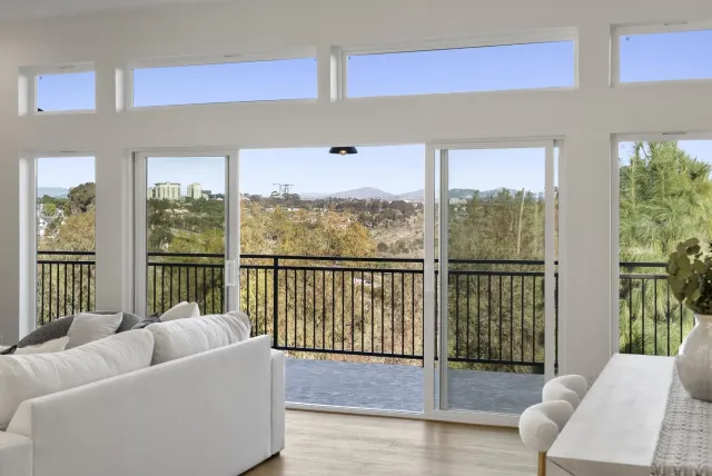 a living room with furniture and view of kitchen