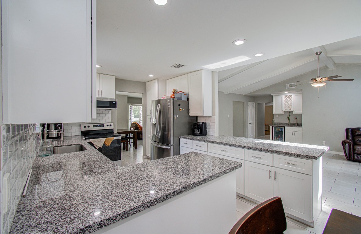 2507 Encreek Road Houston, TX 77068 - Photo 14 of 47 a kitchen with stainless steel appliances granite countertop a sink and a refrigerator