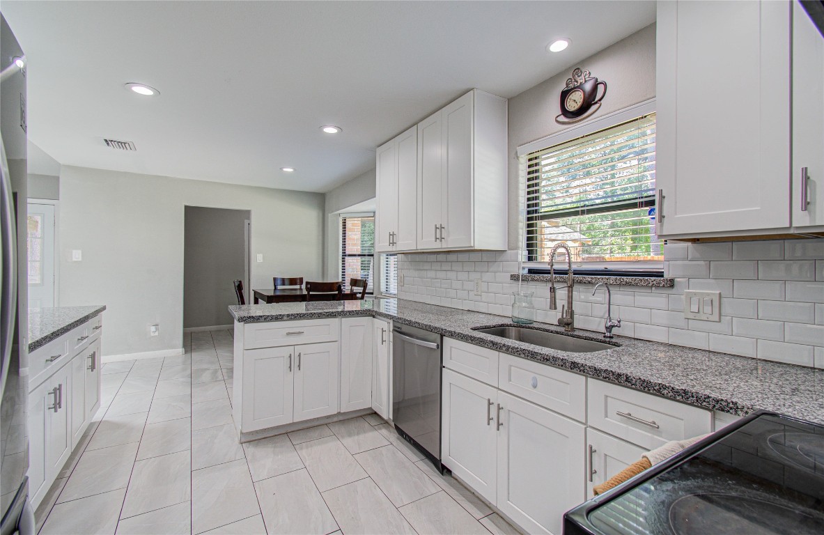 2507 Encreek Road Houston, TX 77068 - Photo 16 of 47 a kitchen with a sink window and cabinets