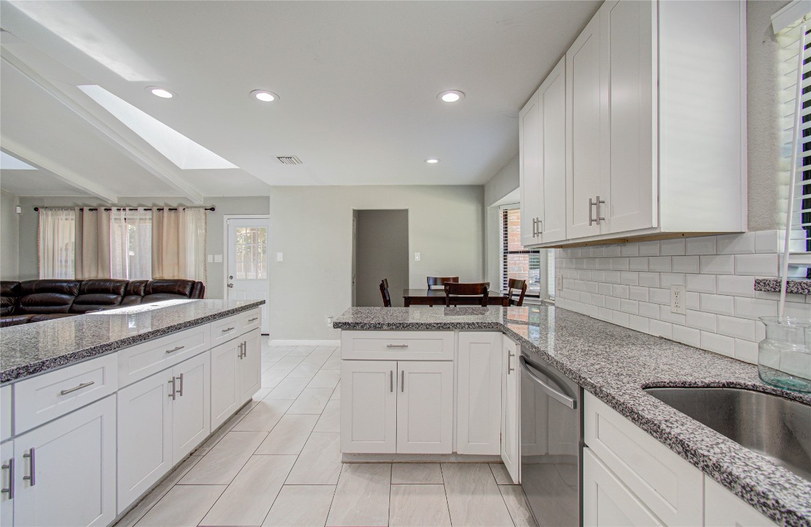 2507 Encreek Road Houston, TX 77068 - Photo 17 of 47 a kitchen with granite countertop white cabinets and white appliances