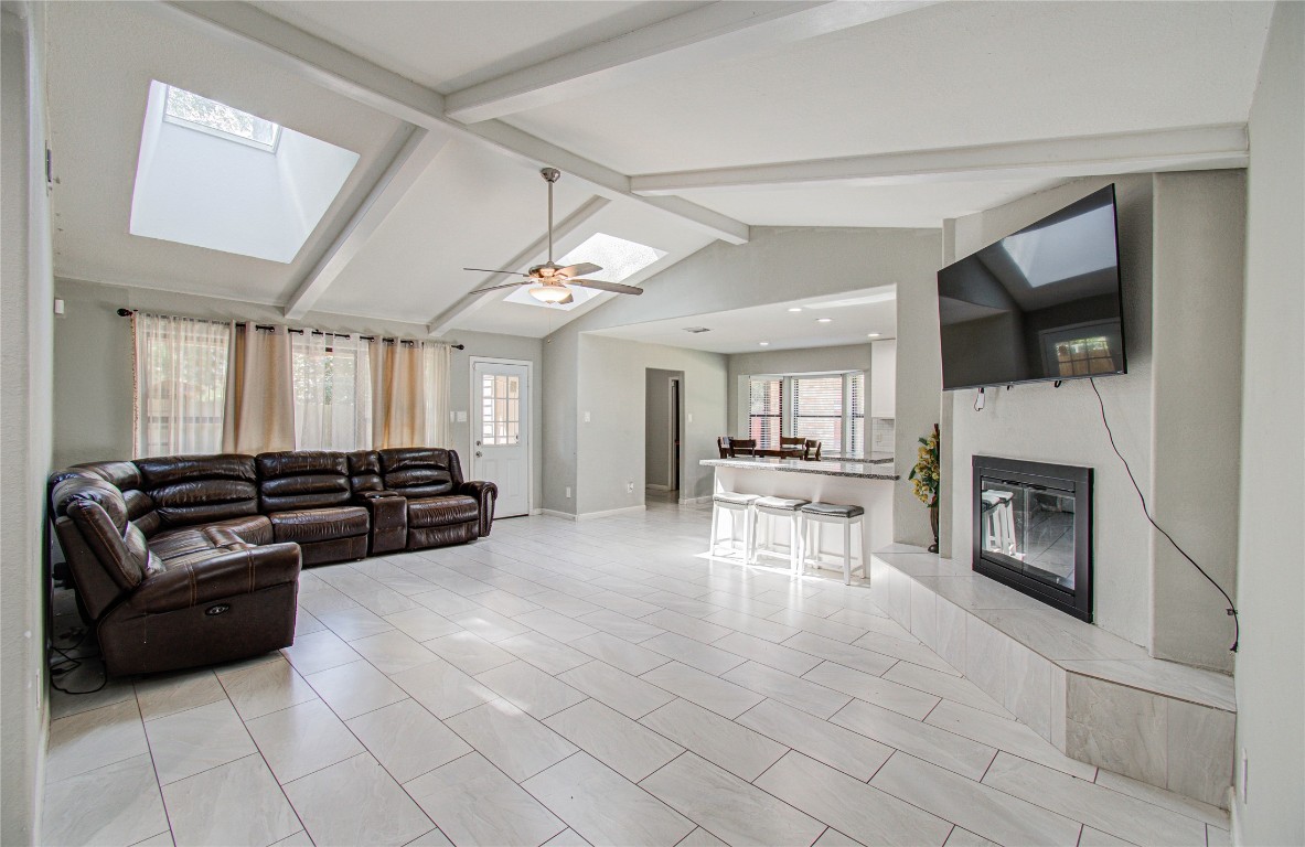 2507 Encreek Road Houston, TX 77068 - Photo 19 of 47 a living room with furniture a flat screen tv and a fireplace
