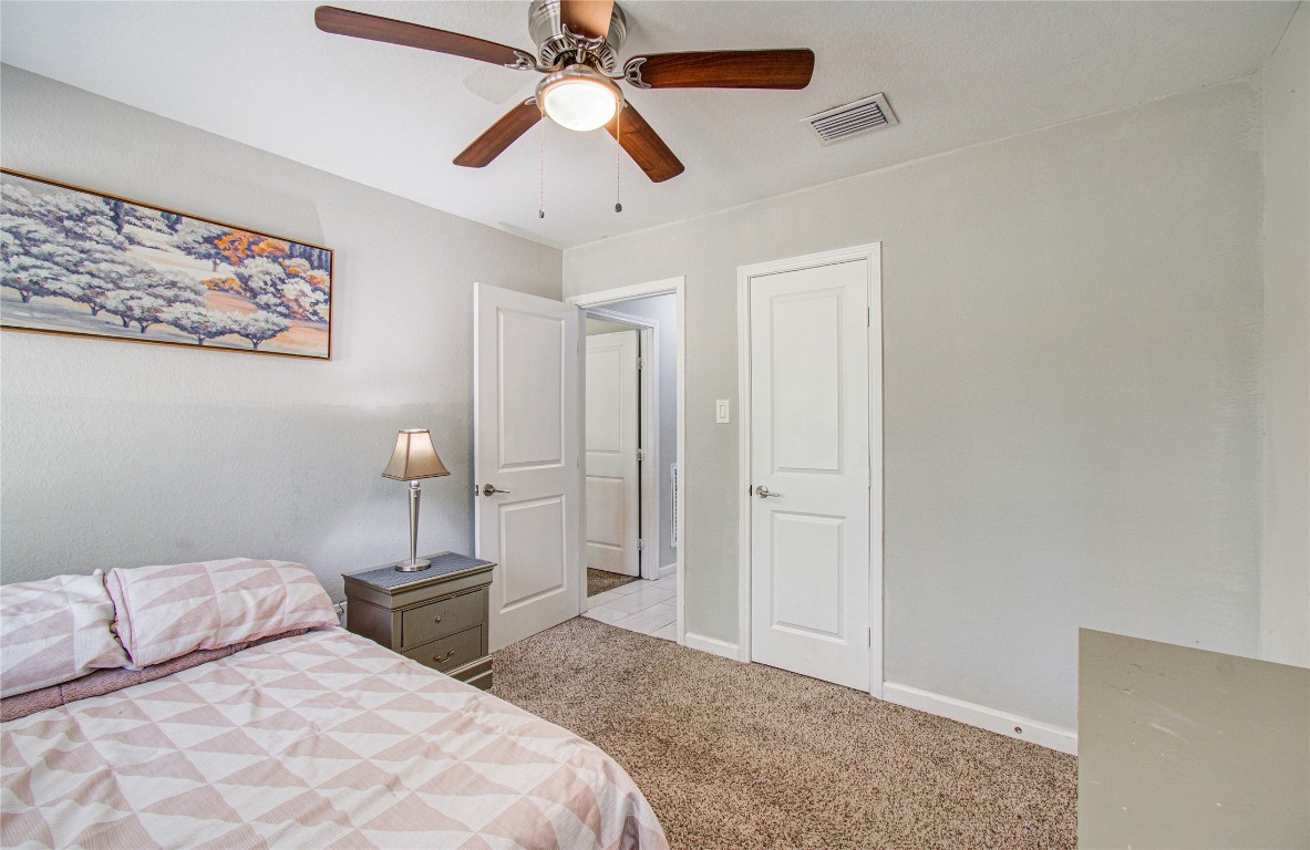 2507 Encreek Road Houston, TX 77068 - Photo 24 of 47 a bedroom with a large bed and a chandelier