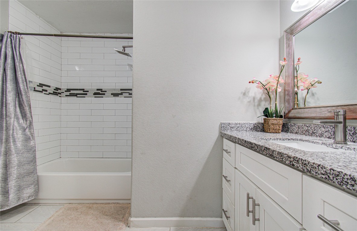 2507 Encreek Road Houston, TX 77068 - Photo 27 of 47 a bathroom with a granite countertop sink a mirror and a bathtub