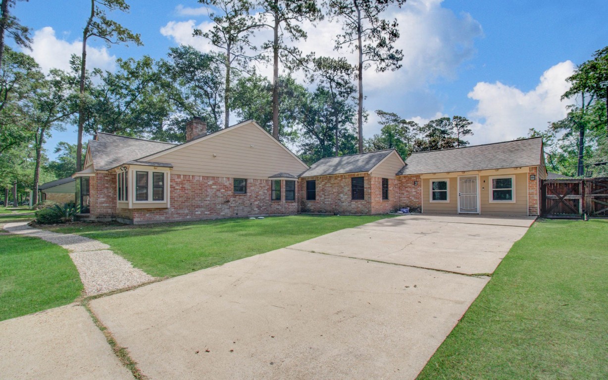 2507 Encreek Road Houston, TX 77068 - Photo 4 of 47 a front view of a house with a yard and trees