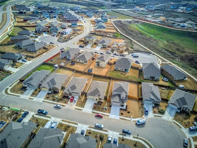 an aerial view of residential houses with outdoor space