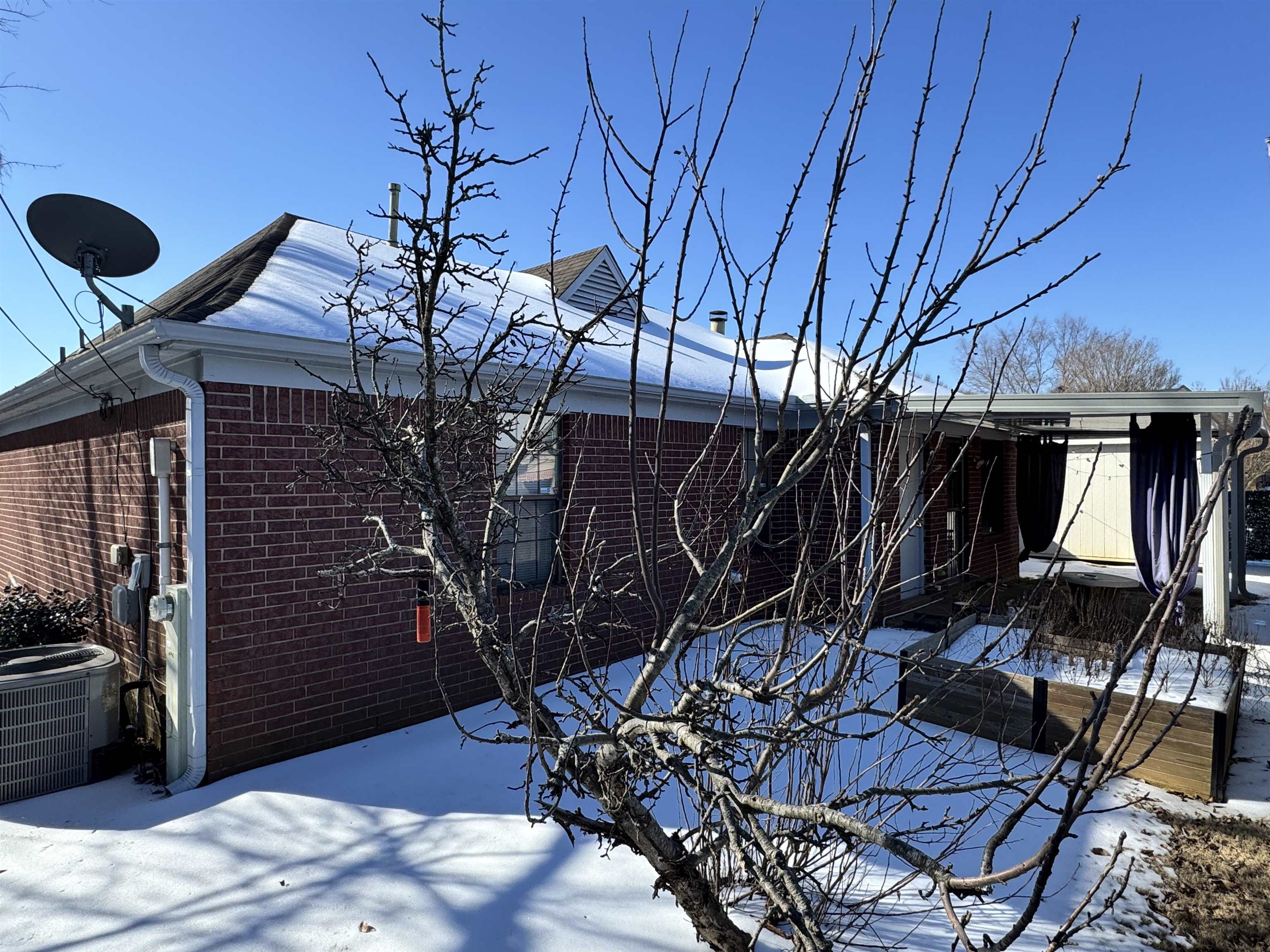 6912 Pleasantwood Road Memphis, TN 38141 - Photo 14 of 20 View of snowy exterior featuring brick siding and a deck