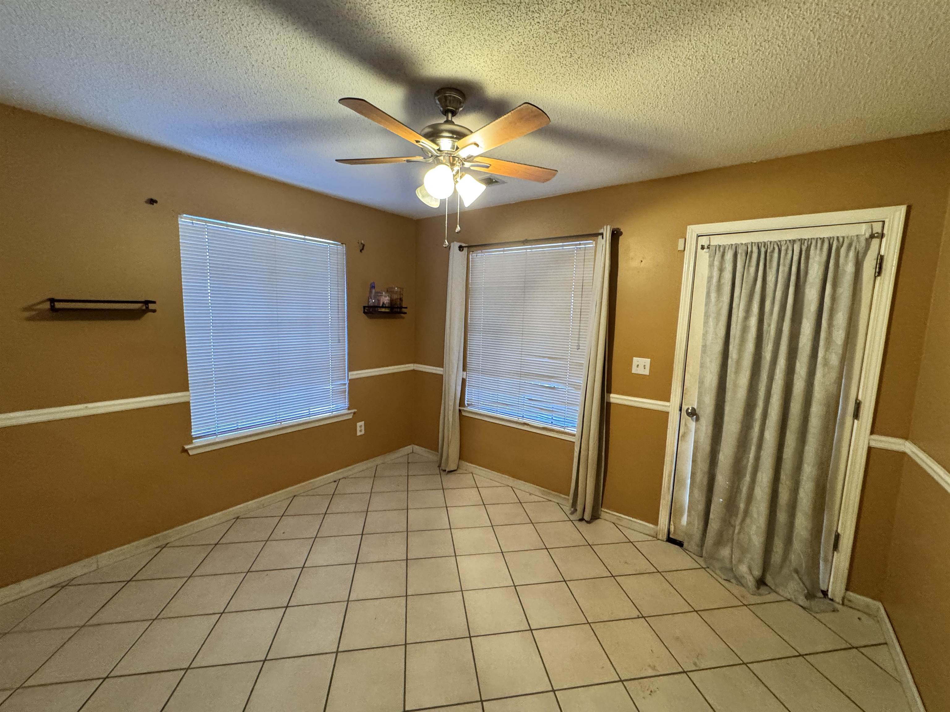 6912 Pleasantwood Road Memphis, TN 38141 - Photo 4 of 20 Empty room featuring a textured ceiling and a ceiling fan