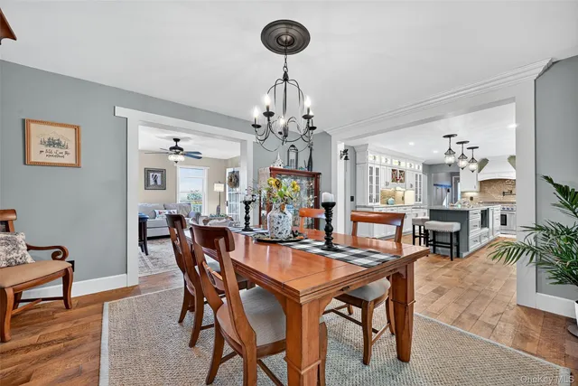 a view of a dining room with furniture and chandelier