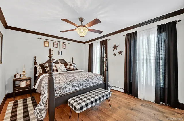 a bedroom with furniture and wooden floor