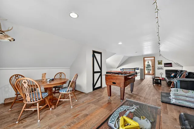 a dining room with furniture and wooden floor