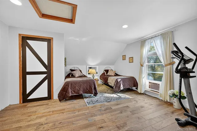 a bedroom with furniture and a window