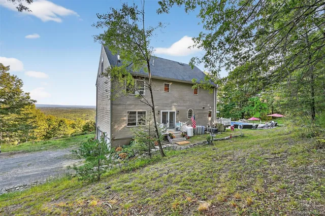 a view of a house with a yard and sitting area