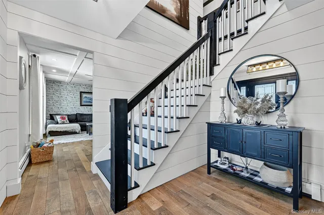 a view of staircase with furniture and wooden floor