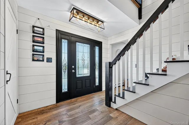 a view of entryway with stairs and wooden floor