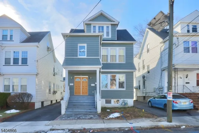 a front view of a building and car parked