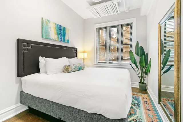 a bedroom with bed and a window