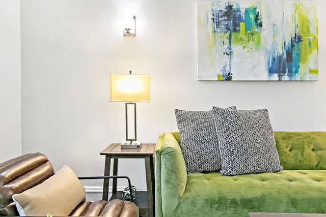 a living room with a couch and a potted plant