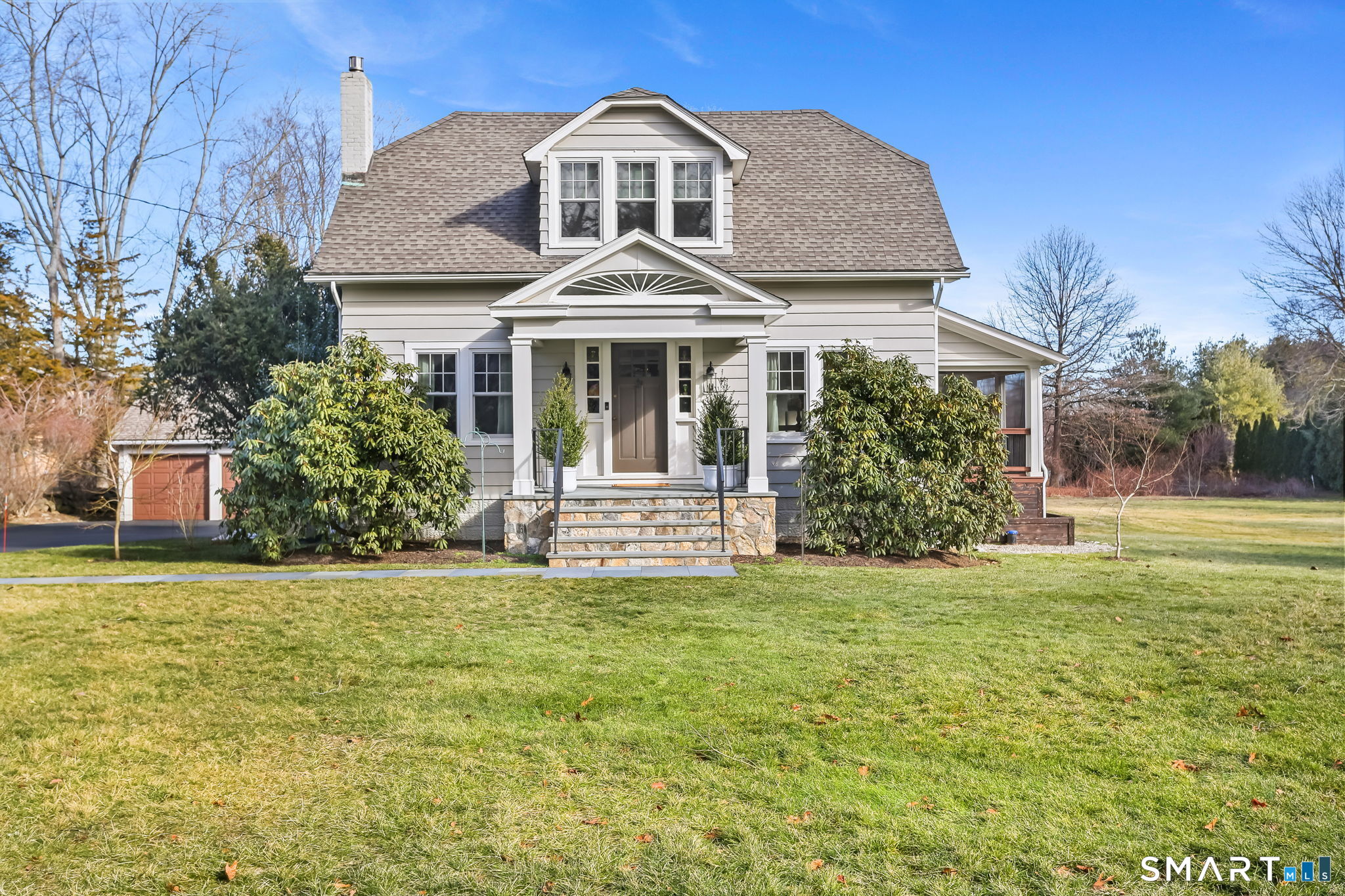 98 Comstock Hill Avenue Norwalk, CT 06850 - Photo 1 of 40 a front view of a house with a garden