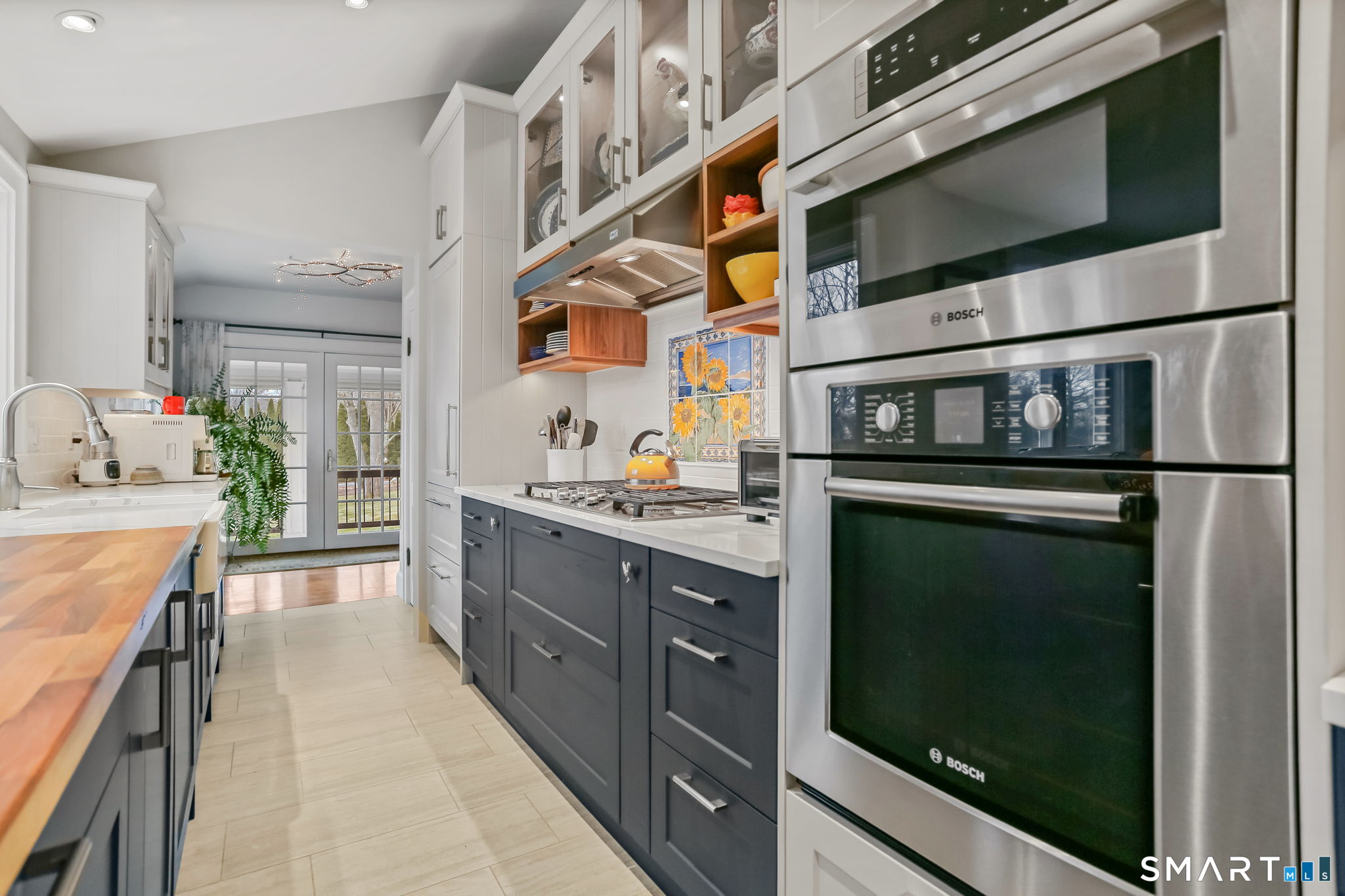 98 Comstock Hill Avenue Norwalk, CT 06850 - Photo 17 of 40 a kitchen with stainless steel appliances granite countertop a refrigerator and a stove top oven