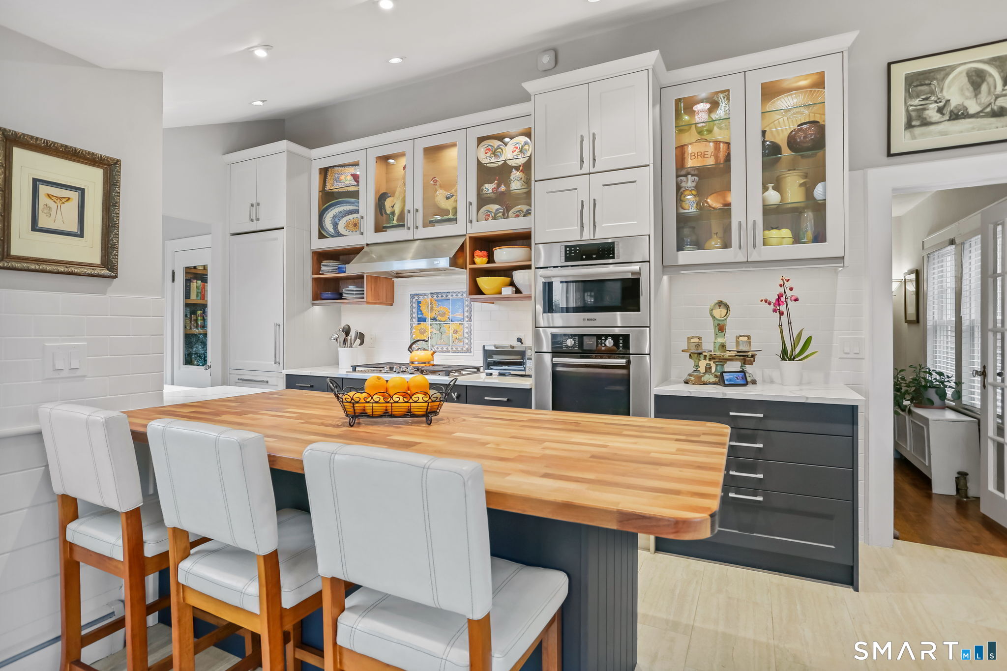 98 Comstock Hill Avenue Norwalk, CT 06850 - Photo 18 of 40 a room with stainless steel appliances kitchen island granite countertop a table chairs and a refrigerator