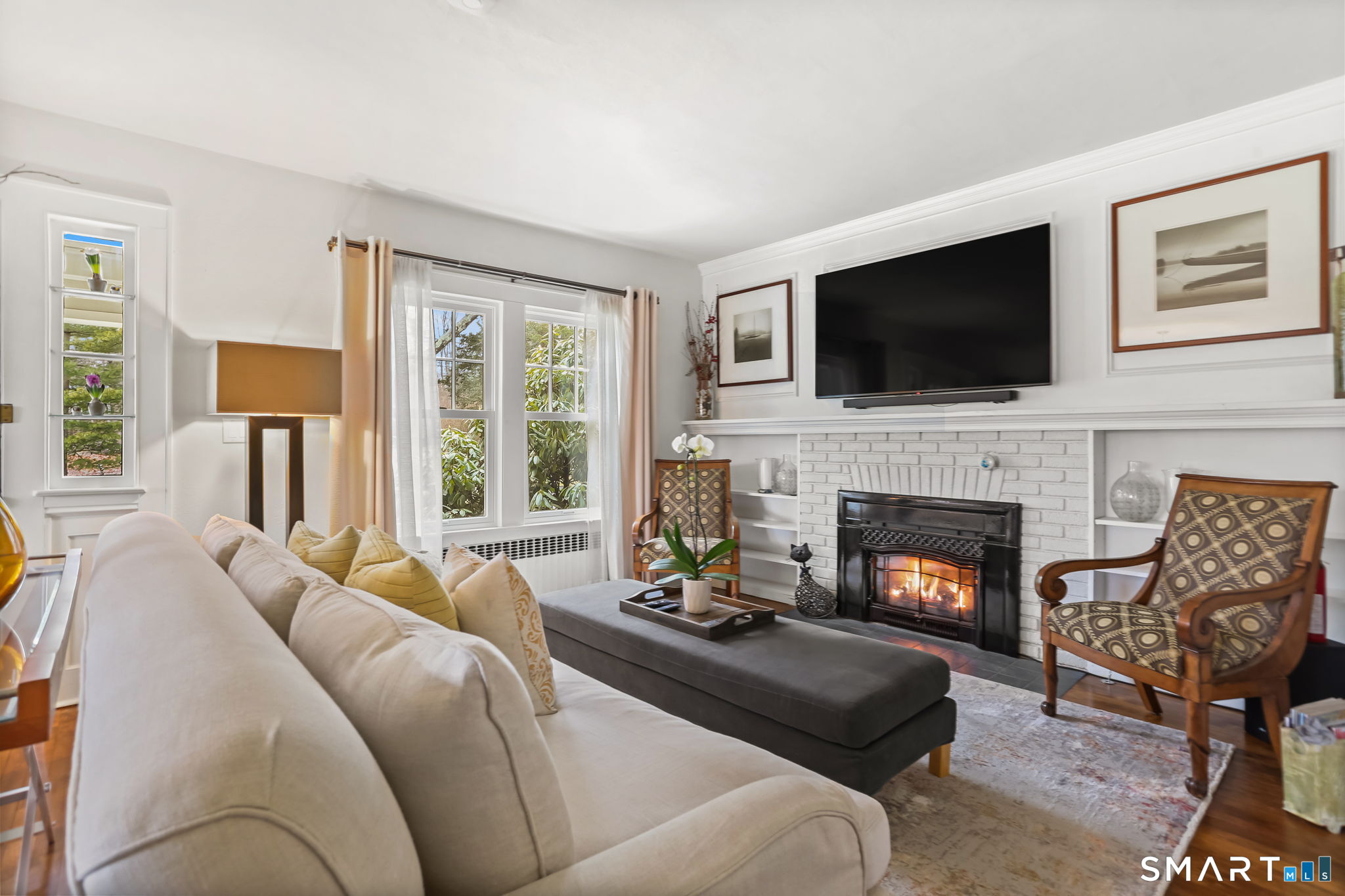 98 Comstock Hill Avenue Norwalk, CT 06850 - Photo 3 of 40 a living room with furniture a fireplace and a flat screen tv