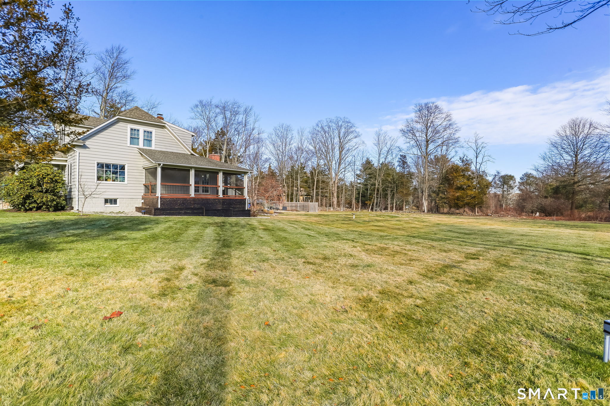 98 Comstock Hill Avenue Norwalk, CT 06850 - Photo 33 of 40 a view of a white house with a big yard and large trees