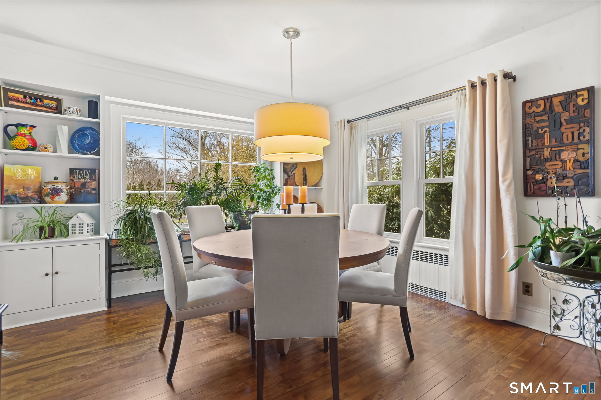 98 Comstock Hill Avenue Norwalk, CT 06850 - Photo 6 of 40 a view of a dining room with furniture window and wooden floor